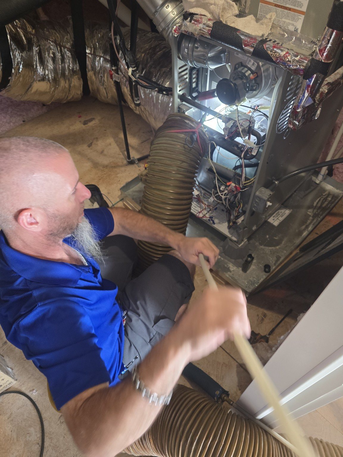 Evaporator coil and blower motor area being cleaned during air duct cleaning service